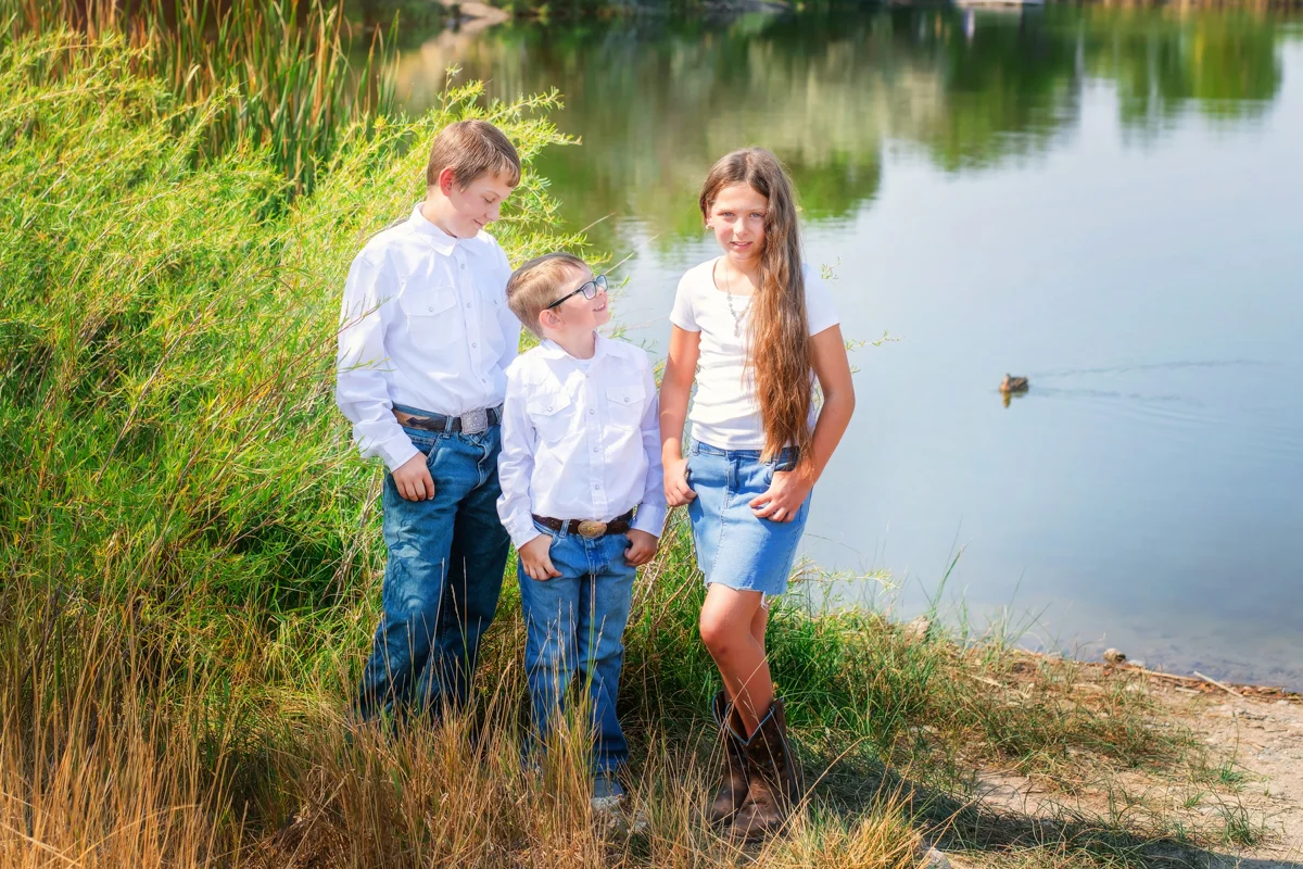 Parents and children beside the water