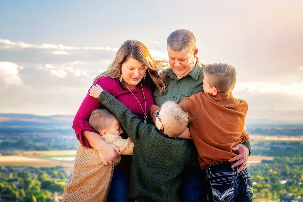 Family of five together at sunset