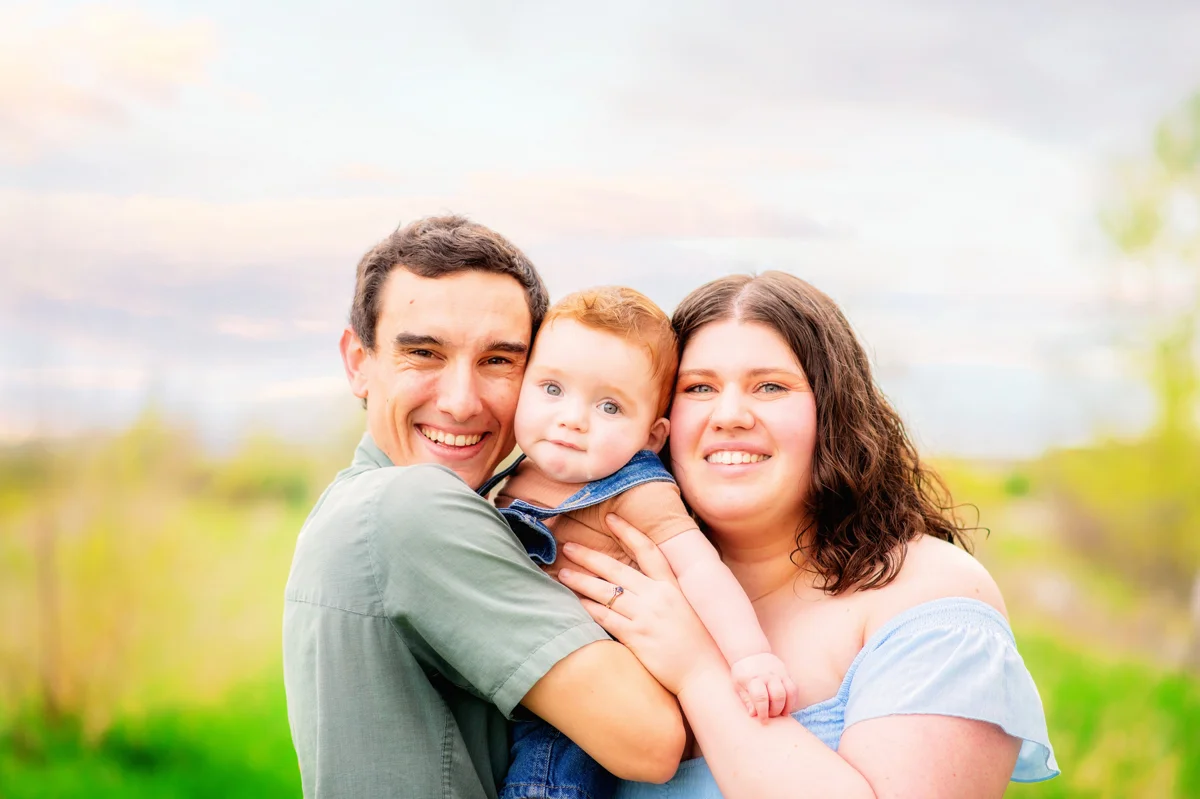 Parents holding their child outdoors