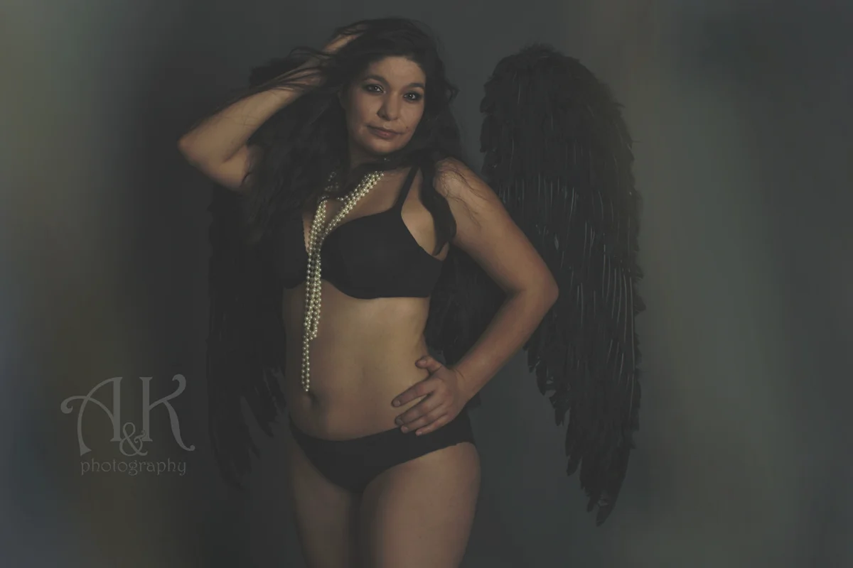 Boudoir portrait with black wings